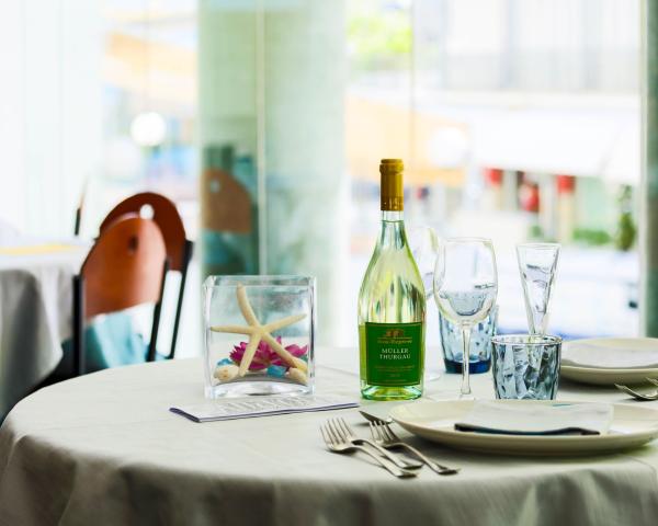 Elegant table with wine bottle and marine decoration.